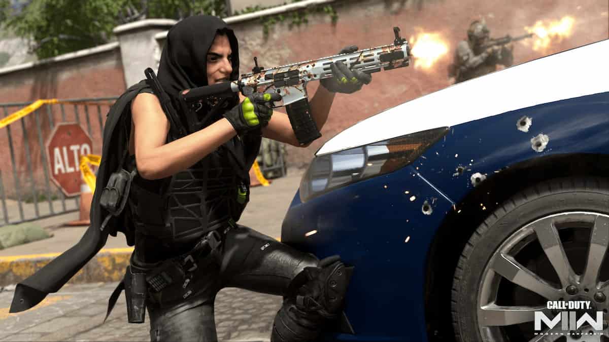 Operative in a hood shooting at an enemy offscreen