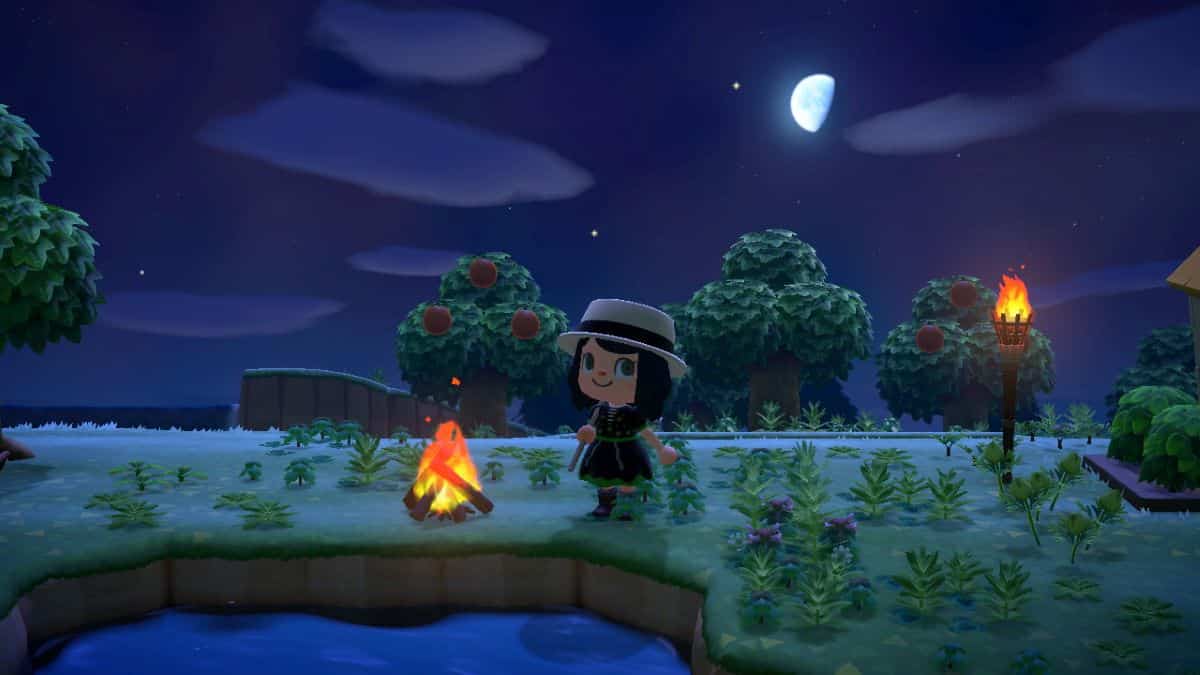 Player sits by the campfire at night in Animal Crossing: New Horizons