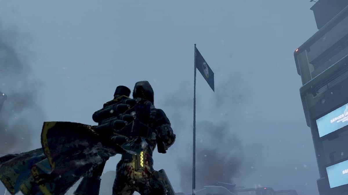 A Helldivers 2 player looks up at the flag.